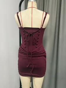 Detailed view of wine red ruched bodycon mini dress featuring a lace-up back design