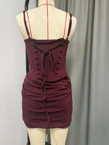 Detailed back view of burgundy sleeveless dress with lace-up straps and ruched design.