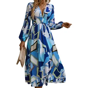 Detail view of bohemian deep V-neck dress with blue geometric print and high waist.