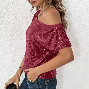 Side view of a burgundy sequined one-shoulder top showing the sparkly material texture.