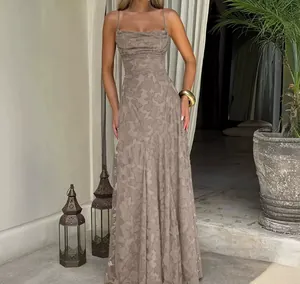 Detailed visual shot of a taupe floral textured slip maxi dress with thin straps.