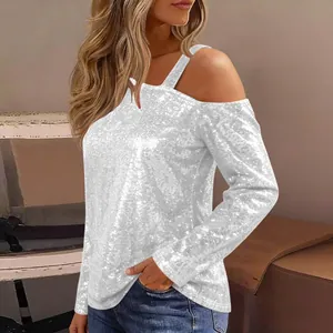 Detail shot of women's silver sequin long sleeve top with stylish cold shoulder design.