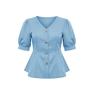 Close-up detail of light blue V-neck blouse with chic puff sleeves and gold buttons
