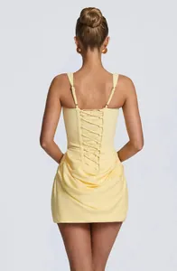 Detailed back view of a yellow sleeveless bodycon dress with lace-up and pleated design
