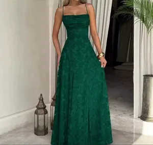 Detailed view of elegant dark green floral pattern on a sexy spaghetti strap maxi dress