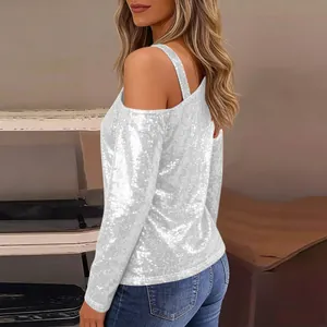 Elegant side view of a white sequin cold shoulder long sleeve top worn by a model