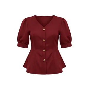 Front view detail of a burgundy V-neck blouse with puff sleeves and gold buttons.