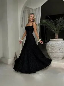 Elegant long black lace spaghetti strap dress with a flared A-line silhouette.