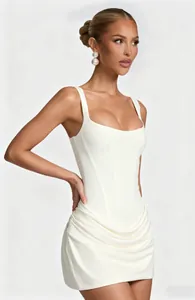 Detailed macro view of a white square neck mini dress with corset bodice and ruched skirt