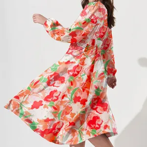 Detailed view of bohemian floral midi dress featuring vibrant red and orange print patterns.