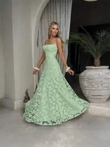 Elegant light green floral lace spaghetti strap maxi dress with a flowing skirt