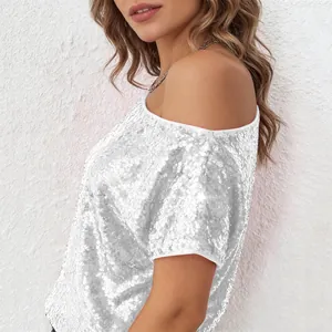 Detail showing the glittering texture of this silver sequin off-shoulder loose T-shirt top