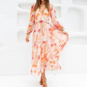 Close-up of bohemian floral maxi dress with deep V-neck and long sleeves
