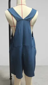 Rear view of a casual blue sleeveless romper jumpsuit featuring a deep V-back design.