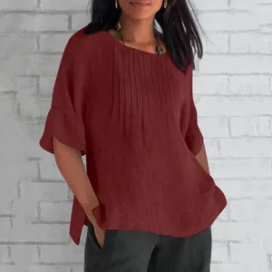 Close-up view of maroon cotton linen women's shirt featuring elegant pleated front details.