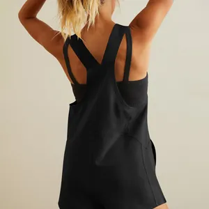 Back view of a casual black V-neck jumpsuit romper showing stylish cross strap detail.