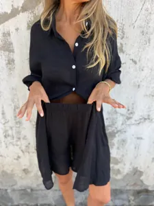 Detail of women's black linen 2-piece set featuring long sleeve shirt and shorts.