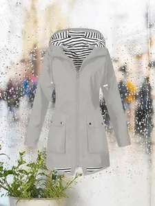 Lightweight women's outdoor hooded jacket in gray with stylish striped lining and pockets.