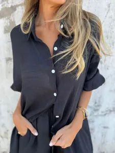 Close-up of textured charcoal cotton linen long-sleeve shirt with white buttons