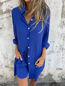 Detail view of vibrant blue cotton linen two-piece set with button-up shirt and shorts