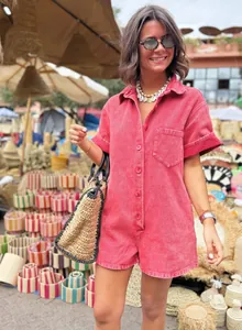 Woman wearing a pink casual short-sleeve romper in a vibrant outdoor market setting