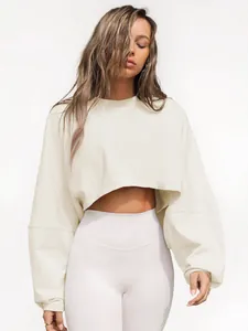 Stylish cream cropped crewneck sweatshirt for women featuring long sleeves and loose fit