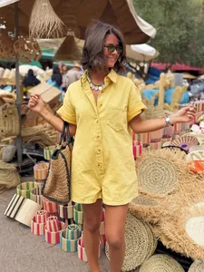 Casual yellow short-sleeve romper with front pocket and button closure