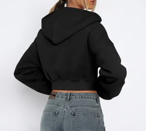 Detailed back view of a black cropped zip-up hoodie with a soft fleece lining texture.