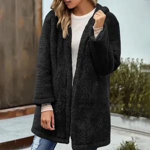 Cozy black fuzzy hooded cardigan jacket for women shown in a casual outdoor setting