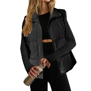 Detail view of a black women's quilted puffer vest with stand collar and zipper closure