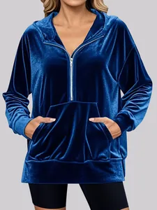 Elegant women's loose blue velvet hoodie featuring half-zip and front kangaroo pocket
