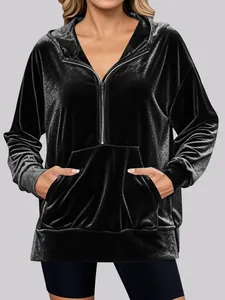 Stylish women's black velvet oversized hooded sweatshirt featuring a half-zip and front pocket