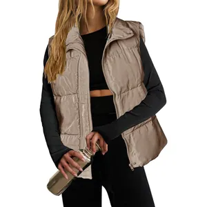 Detailed view of women's khaki padded puffer vest with stand collar and zipper closure.
