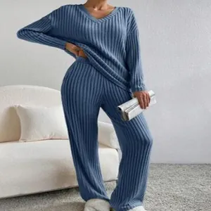 Detailed view of women's blue ribbed knit two-piece set with V-neck top and wide-leg pants