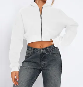 Detailed view of white cropped zip-up hoodie with fleece lining and street style