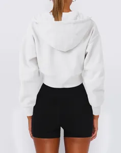Back view of a minimalist white cropped hooded sweatshirt featuring a casual street style