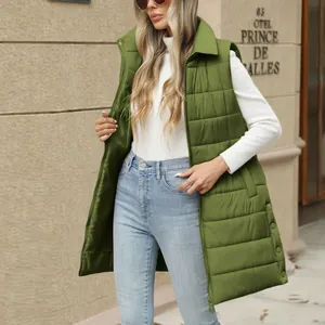 Women's mid-length quilted green puffer vest with zipper pockets shown in street style