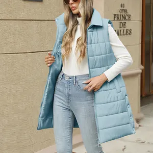 Detail view of the light blue mid-length quilted puffer vest with zipper closure.