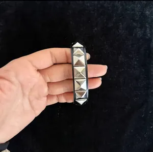 Close-up of punk leather bracelet with silver square pyramid studs for men