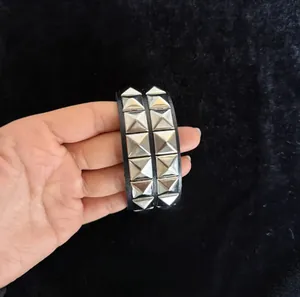Close-up of a double-layer punk leather bracelet with silver pyramid studs