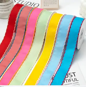 Detailed view showing colorful 2.5cm ribbed grosgrain ribbons with scalloped edges