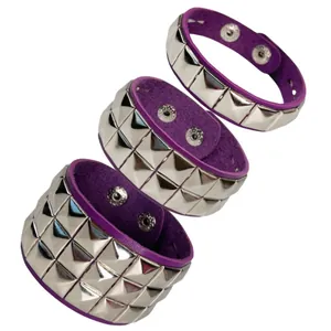 Detail view of punk rock leather wristbands with silver square rivets and purple lining