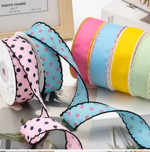 Detail of 2.5cm scalloped grosgrain ribbons with polka dot patterns for gift wrapping