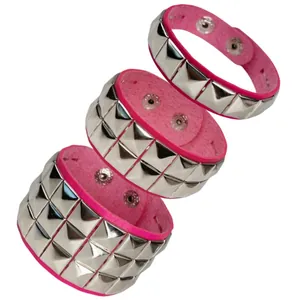 Close-up of pink punk leather bracelets with silver square rivets and snap buttons