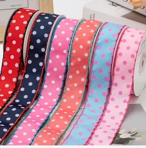 Detailed view of colorful 2.5cm polka dot grosgrain ribbons with elegant scalloped edges