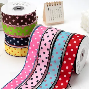 2.5cm polka dot grosgrain ribbon with scalloped edges for DIY crafts and gift wrapping.