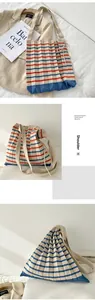Macro view of the accordion pleated knit texture and blue red stripes on this niche tote bag