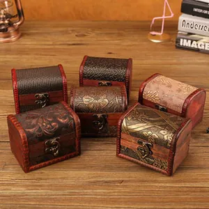 Detailed view of multiple vintage wooden storage boxes with ornate patterns and metal latches
