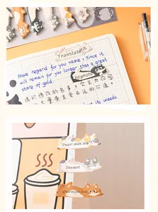 Close-up of cute cat-shaped paper index tabs used for labeling in a grid notebook