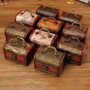 Collection of vintage wooden jewelry boxes with antique floral patterns and metal handles